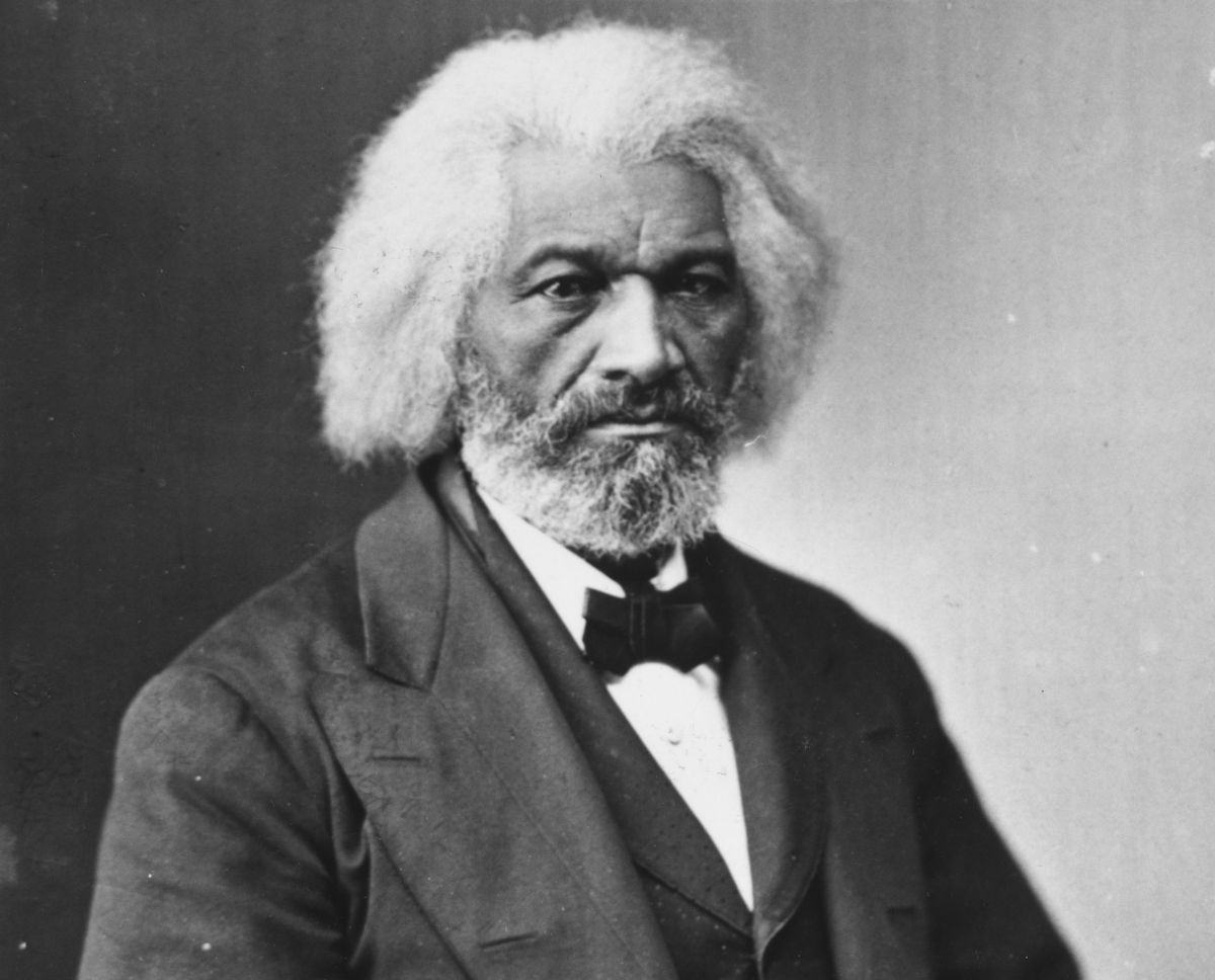 frederick douglass posing for camera in a suit