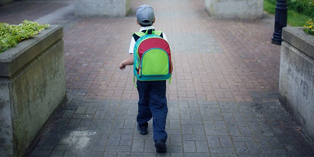 Green, Yellow, High-visibility clothing, Standing, Asphalt, Sidewalk, Outerwear, Personal protective equipment, Road surface, Road, 