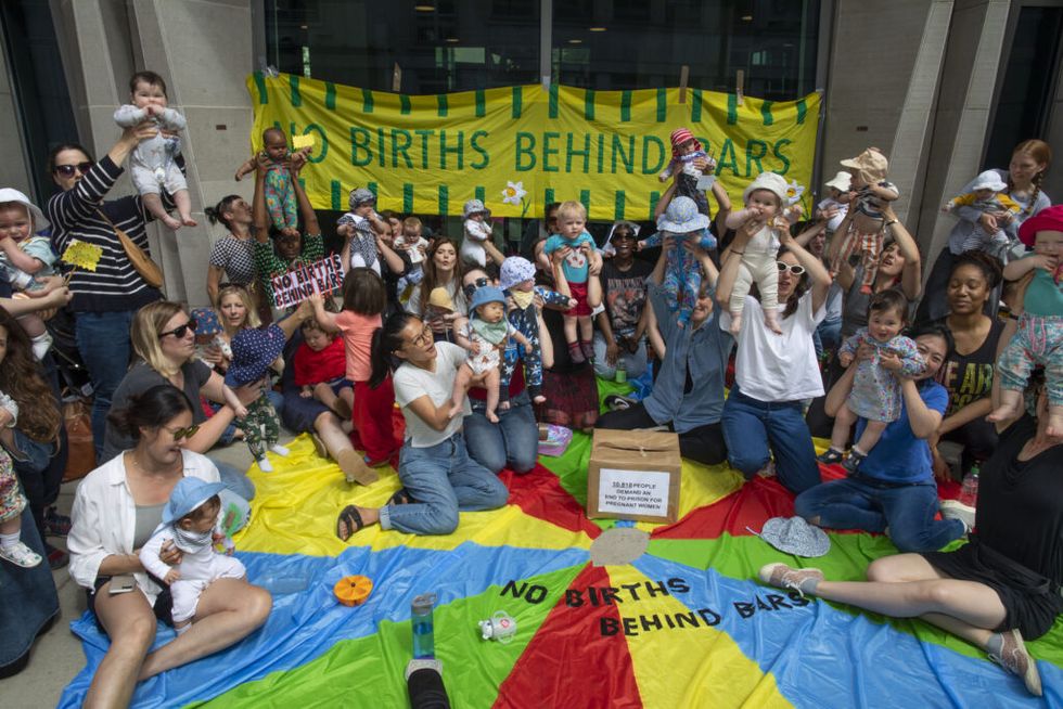 a group of mothers, midwives and campaigners host a protest outside the ministry of justice to demand an end to the imprisonment of pregnant women and new mothers in london, uk tuesday, june 7, 2022