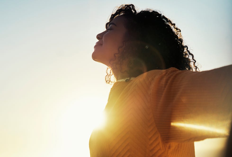 woman breathing in the sunlight