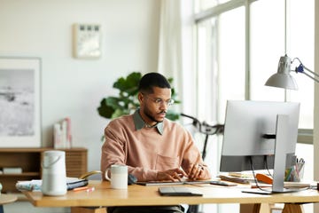 freelancer using computer at home office