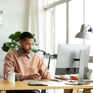Freelancer Using Computer At Home Office freelancer using computer at home office