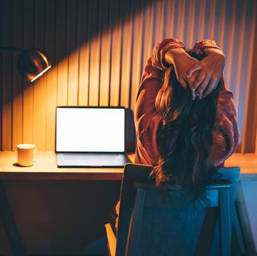 freelancer woman works at laptop in evening