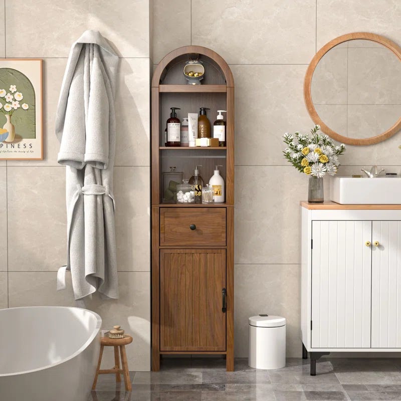 bathroom storage unit with a towel toiletries and a washbasin