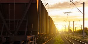 freight wagons on the railroad at sunset rail freight and passenger transportation