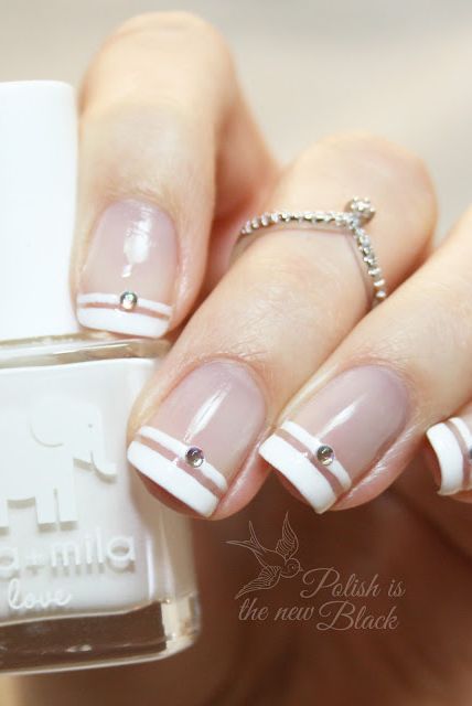 White nail polish with gold and silver rhinestones. White nail art !