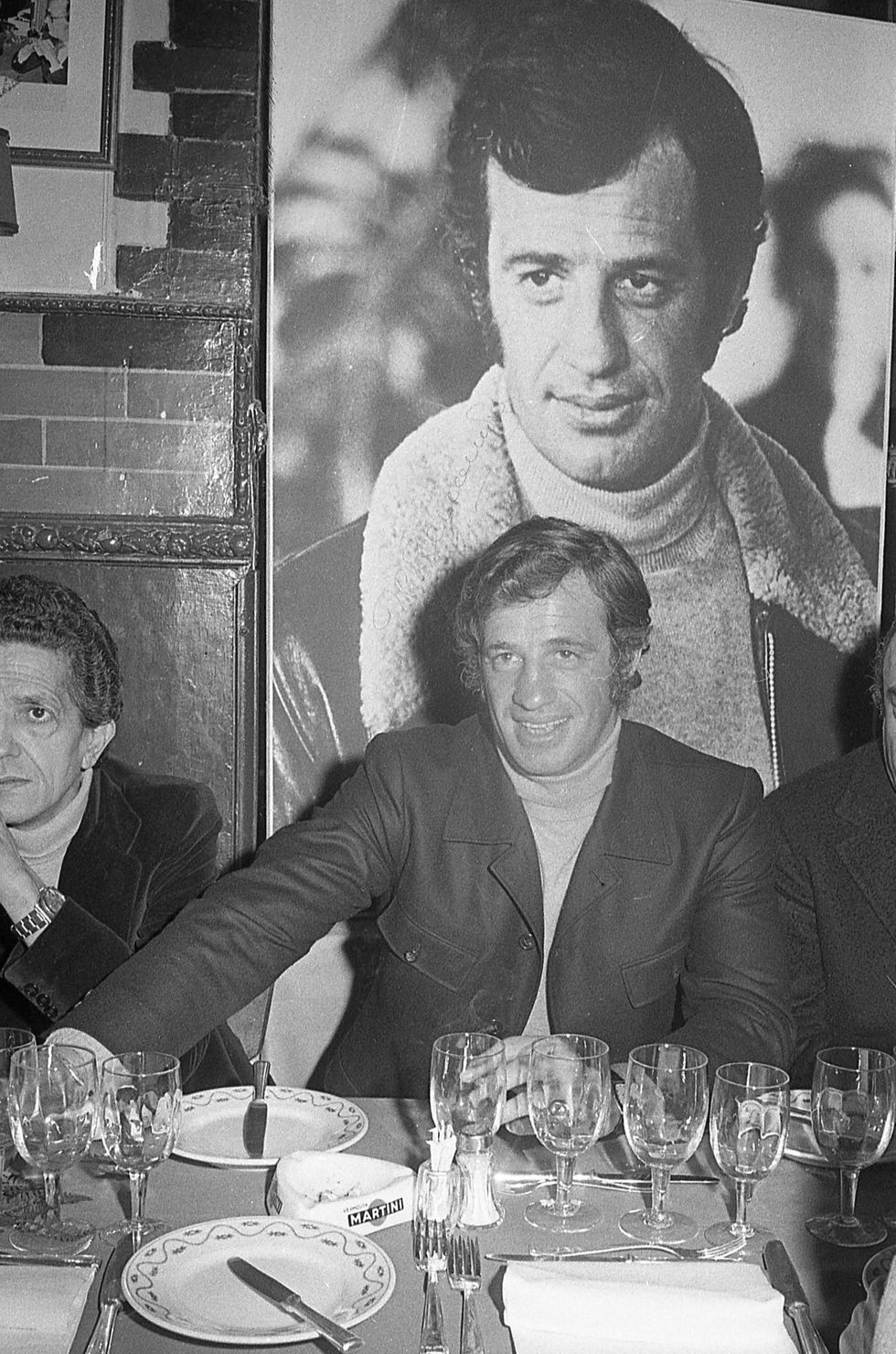 french actor jean paul belmondo has dinner at the 'taverna flavia', rome 1971
