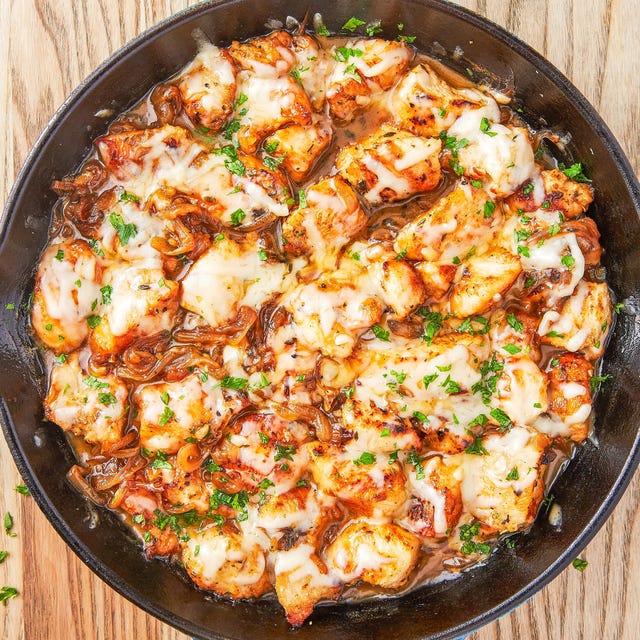 chicken in a pan with cheese and caramelized onions