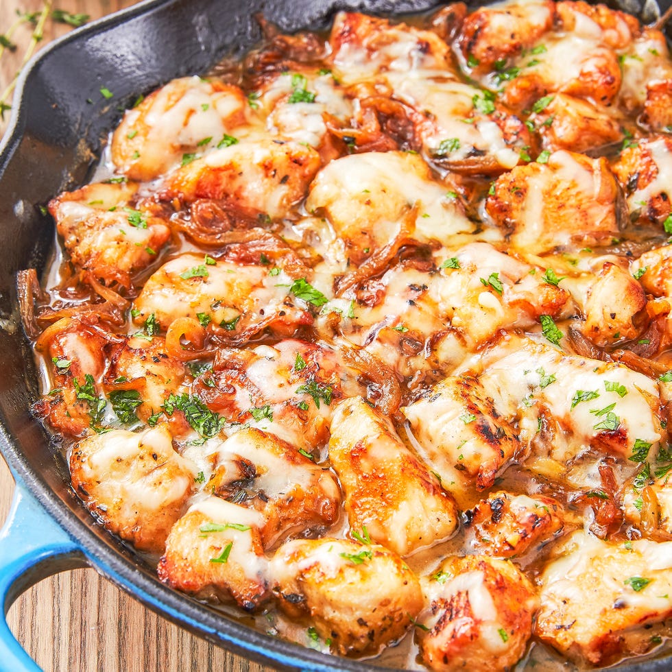 chicken in a pan with cheese and caramelized onions