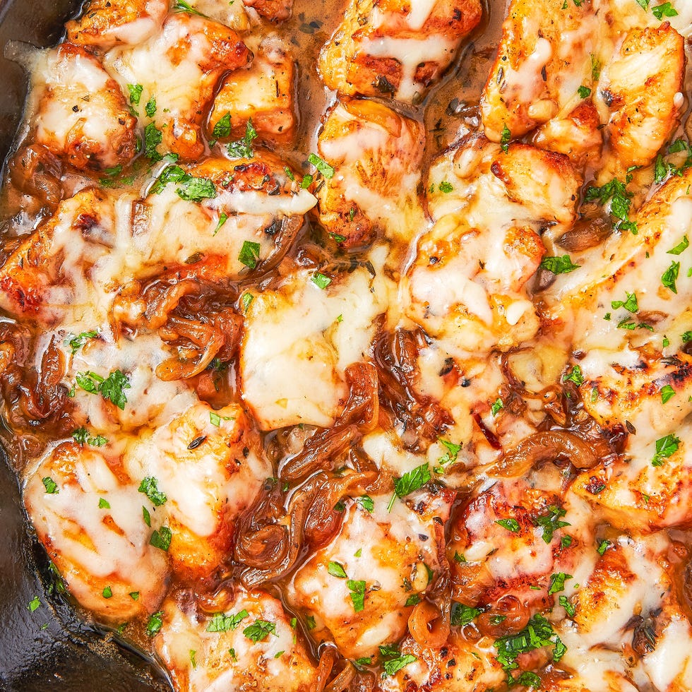 chicken in a pan with cheese and caramelized onions