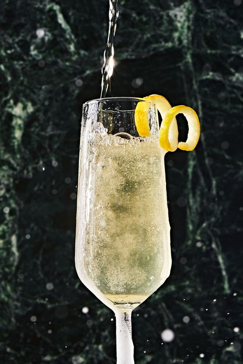 french 75 in a flute garnished with a lemon twist