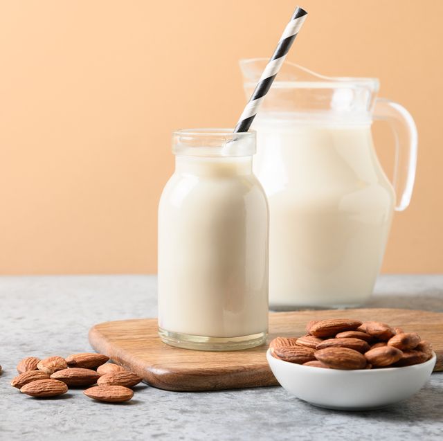 fresh almond milk in glass bottle and jug healthy vegan eating lack of cholesterol