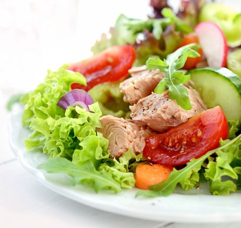 a fresh and colorful tuna salad on a white plate