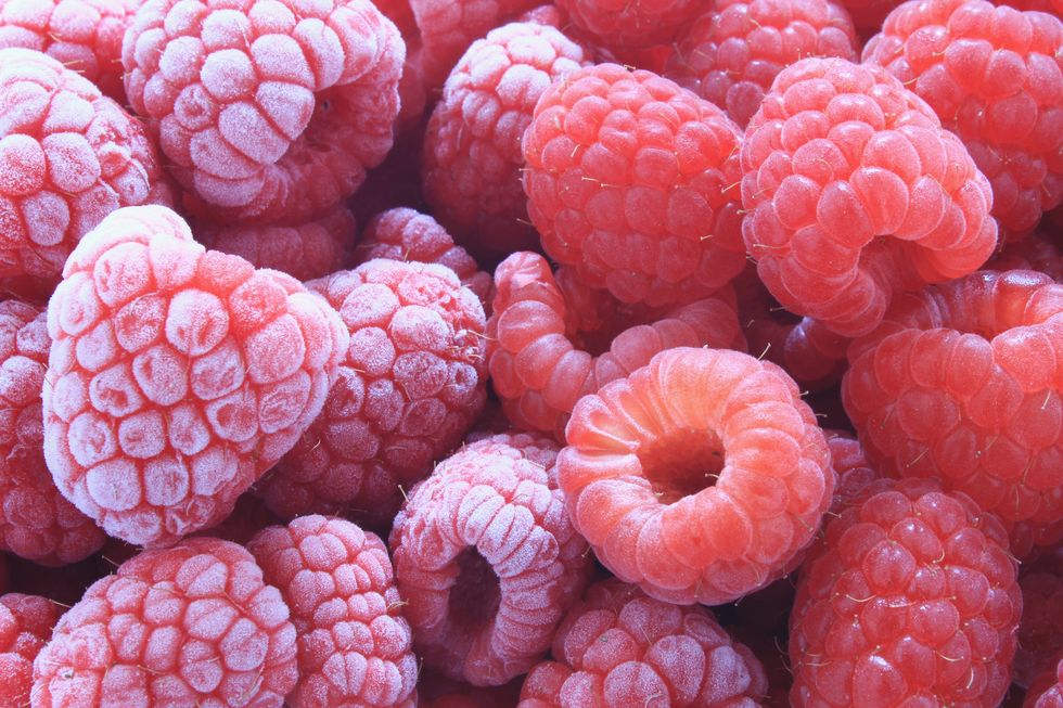 fresh and frozen raspberries close up