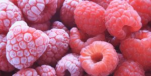 fresh and frozen raspberries close up