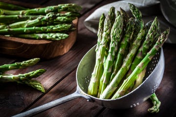 fresh asparagus in an old metal colander