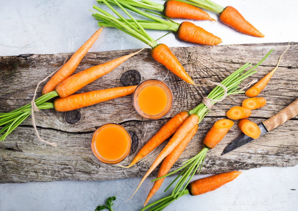 https://hips.hearstapps.com/hmg-prod/images/fresh-carrot-juice-and-raw-organic-vegetables-over-royalty-free-image-1571343905.jpg?crop=0.712xw:1.00xh;0.228xw,0&resize=980:*