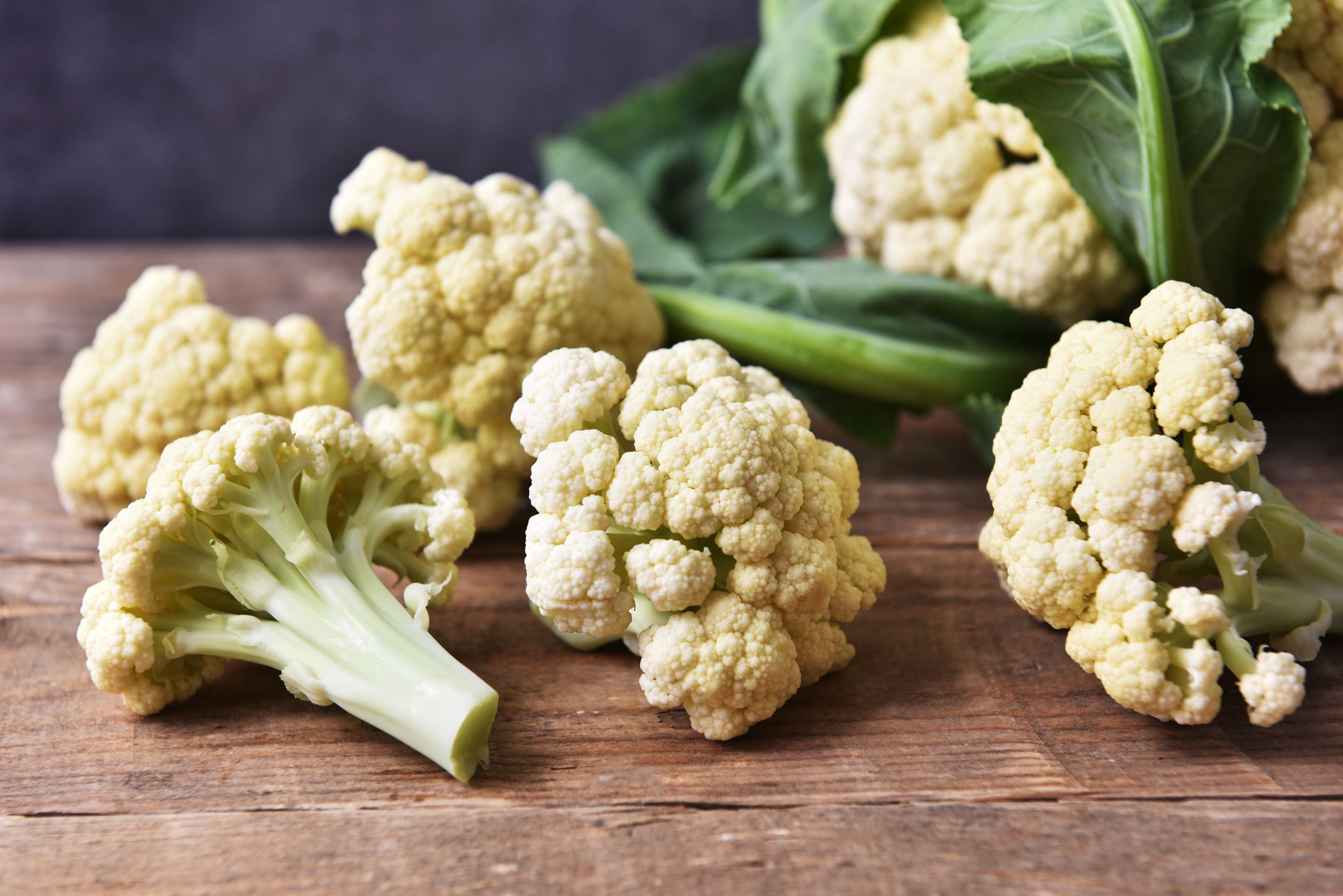 https://hips.hearstapps.com/hmg-prod/images/fresh-cauliflower-on-wooden-table-royalty-free-image-1676393468.jpg