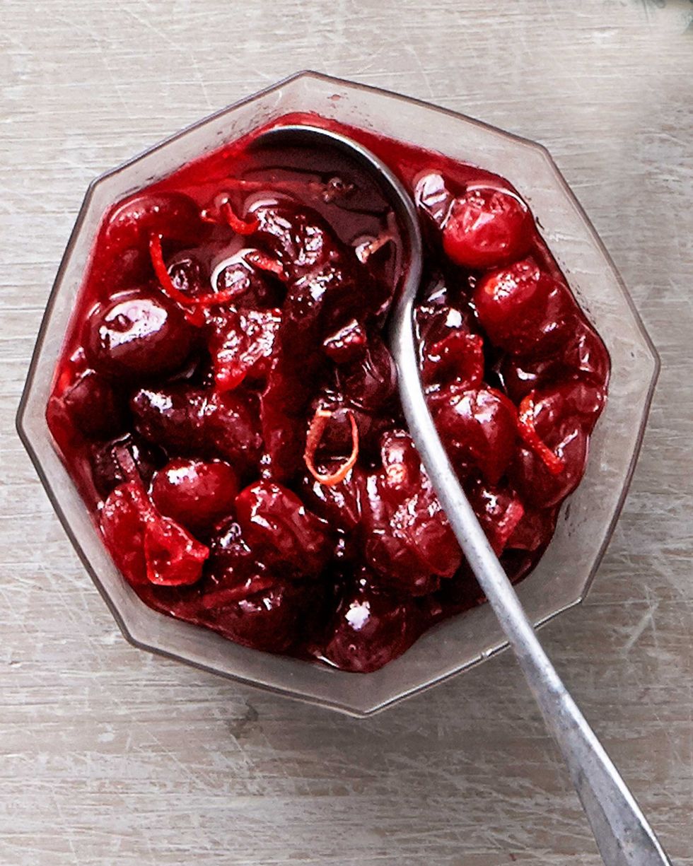 citrus cranberry sauce in a glass bowl with a spoon for serving