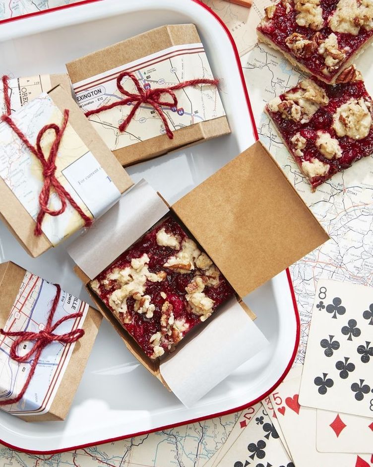 cranberry crumb bars cut into squares and packaged in individual boxes with red string