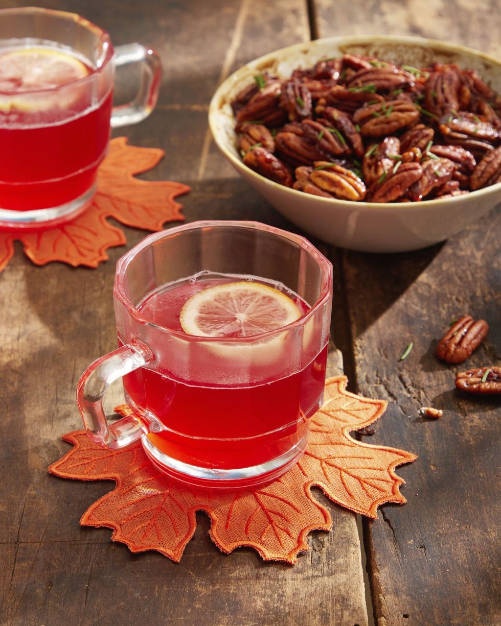 cranberry mulled white wine in glass mugs with a slice of lemon