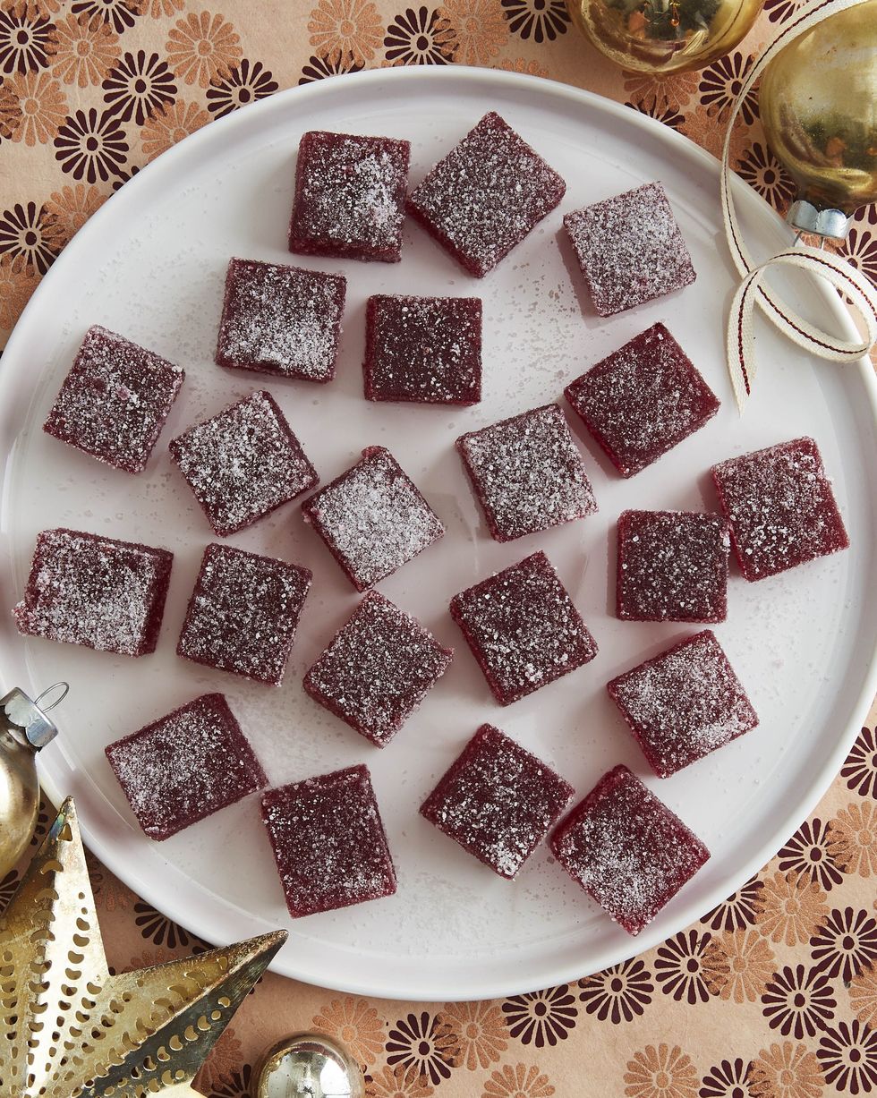 cranberry pâte de fruit in squares and arranged on a white plate