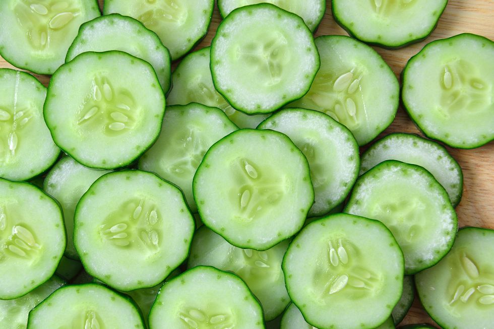 fresh cucumber and slices white background,romania
