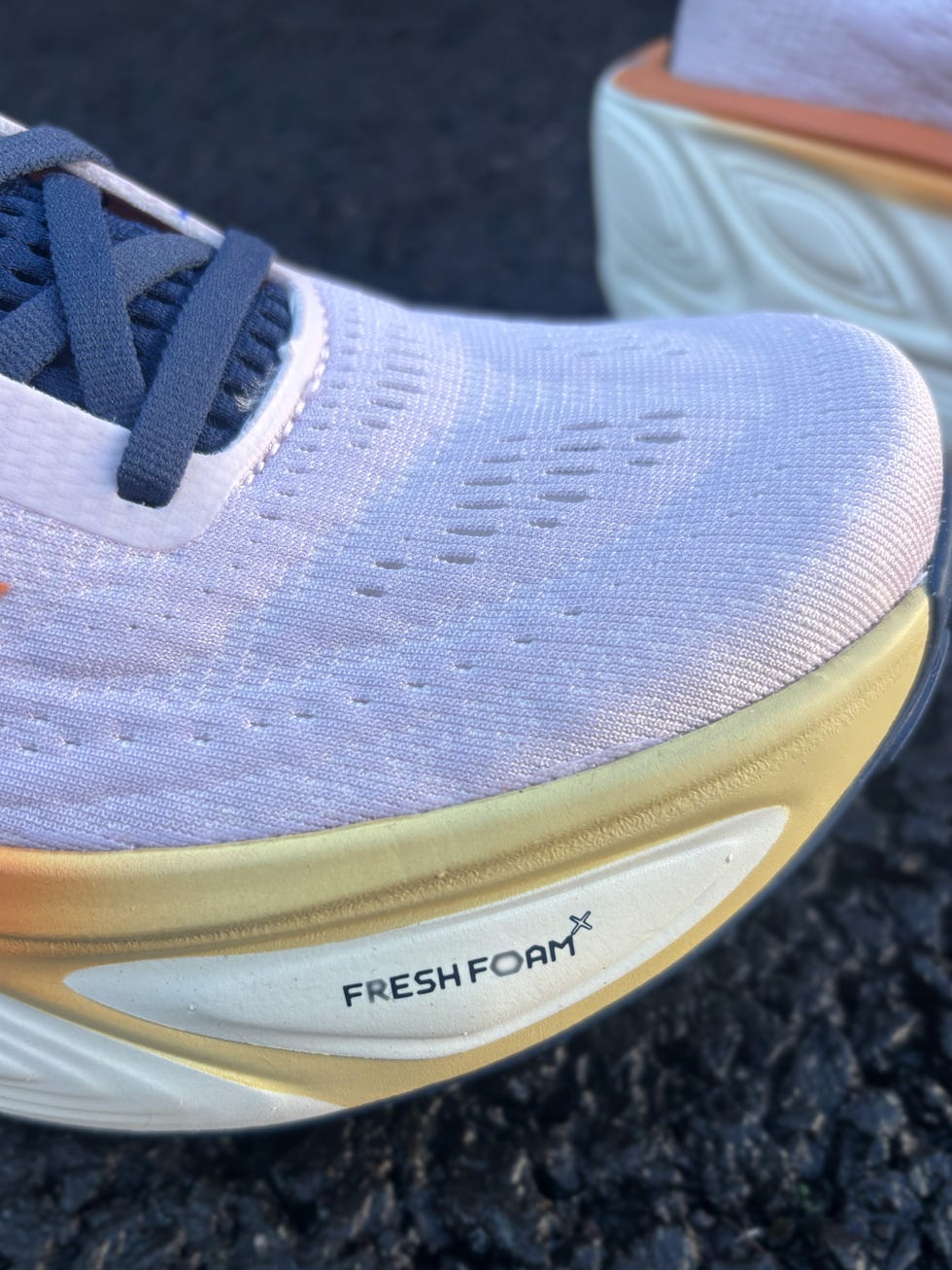 close up of a pink running shoe with the text fresh foam x on the outside
