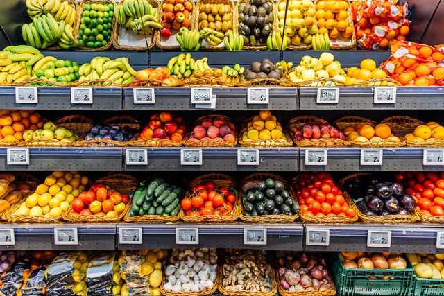 fresh fruits and vegetables on a market stall for sale at the supermarket