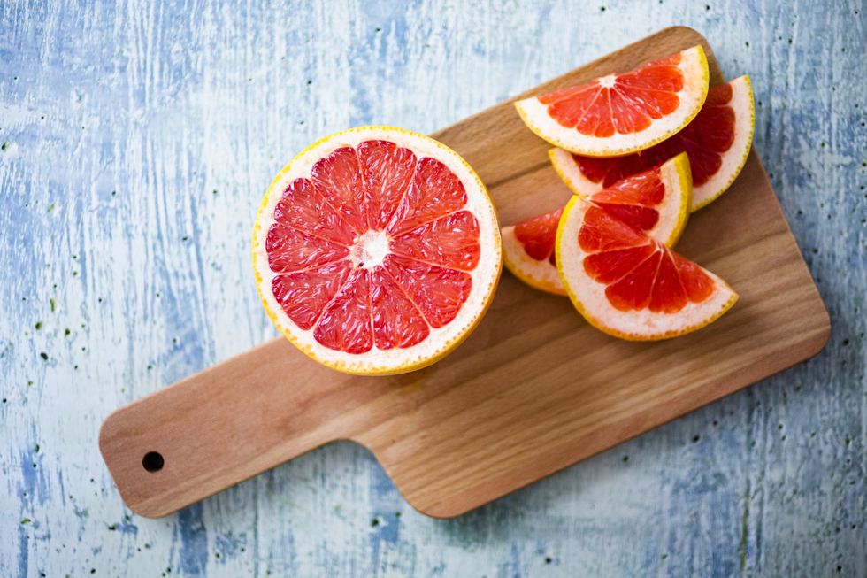 fresh grapefruit on chopping board