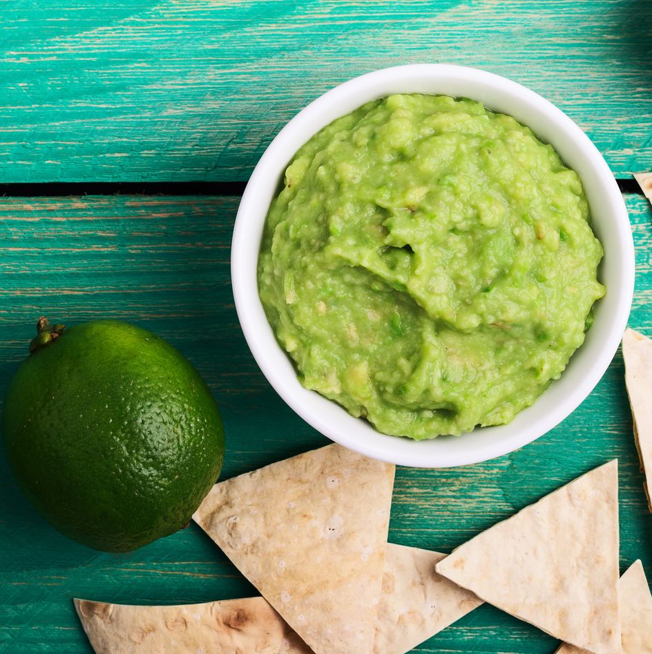 Fresh guacamole dip with lime juice and tortilla chips