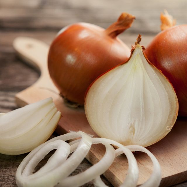 fresh healthy onions on chopping board