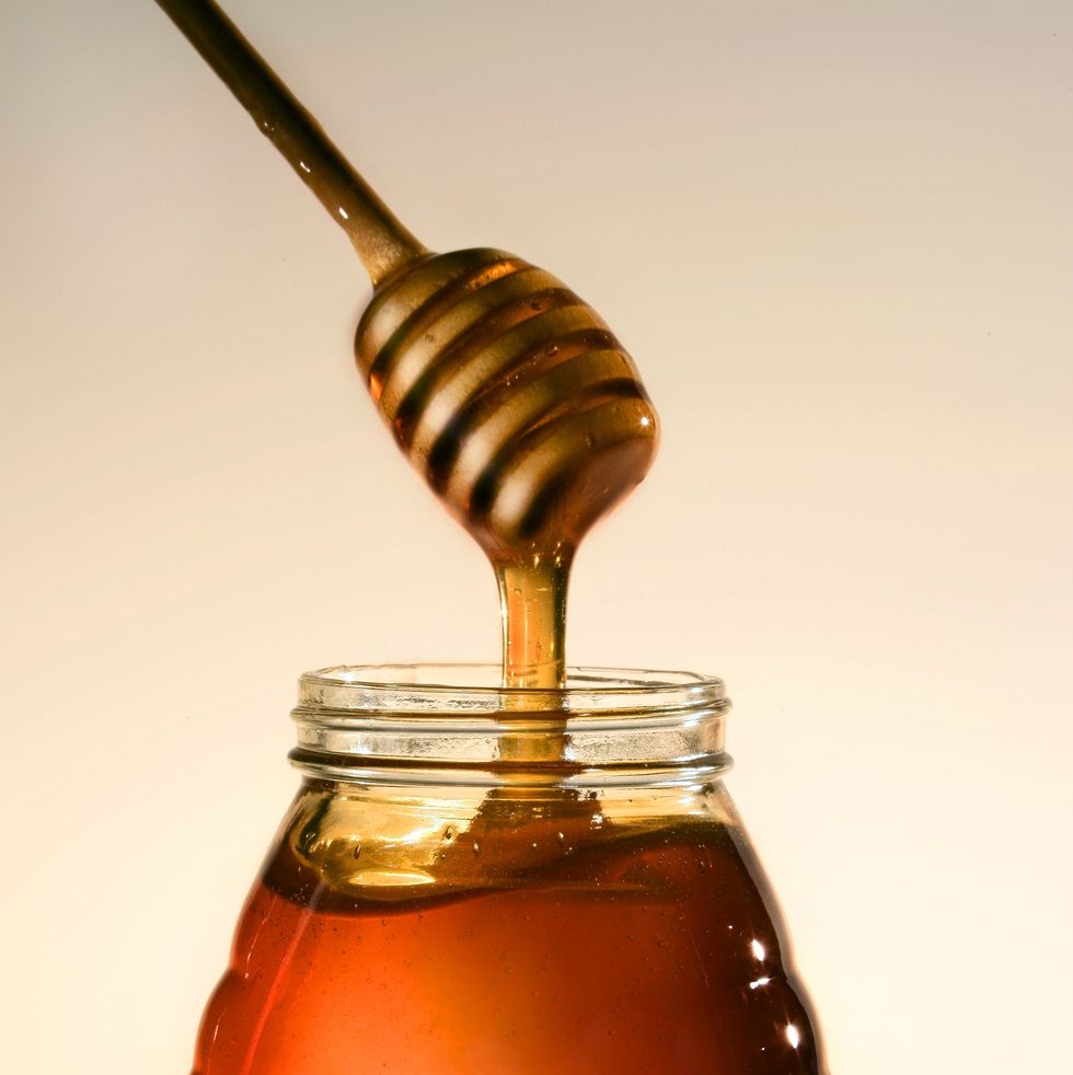 fresh honey dripping from dipper