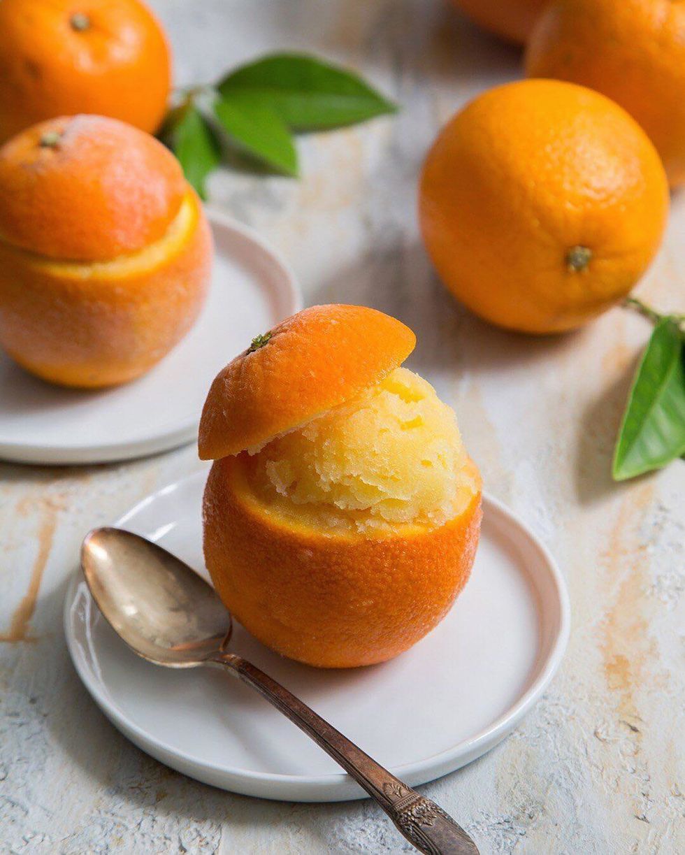 fresh orange sorbet with spoon in white background
