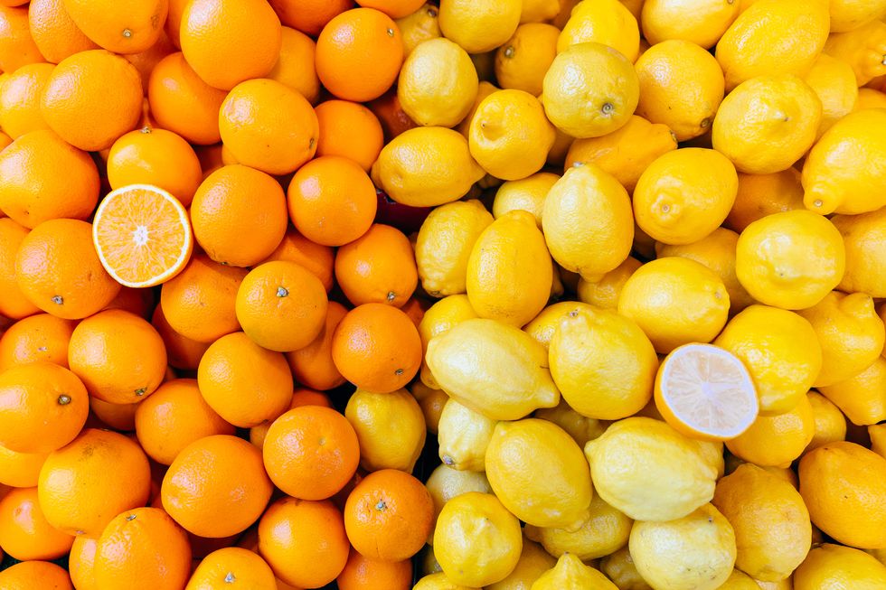 Fresh oranges and lemons on a market stall