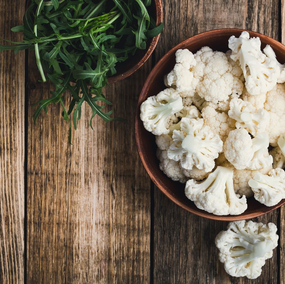 fresh organic cauliflower cut into small pieces in a bowlvegetarian recipe or menu background with copy space