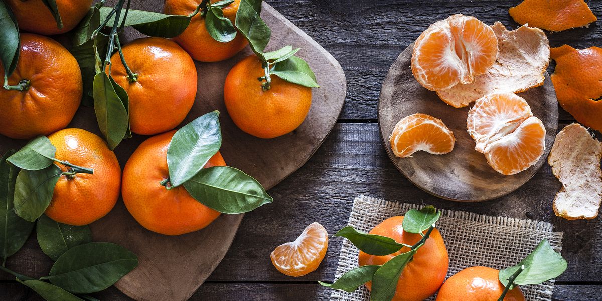 fresh organic mandarins on rustic wooden table
