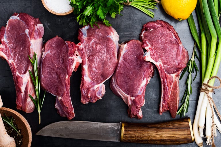 fresh raw uncooked veal steaks with ingredients