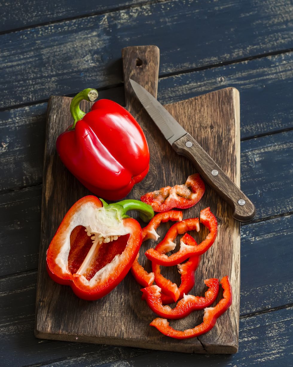 fresh red sweet pepper on a wooden rustic board