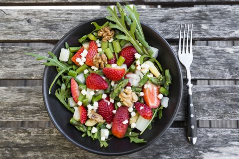 fresh salad of asparagus, strawberries, rocket, feta cheese and walnuts