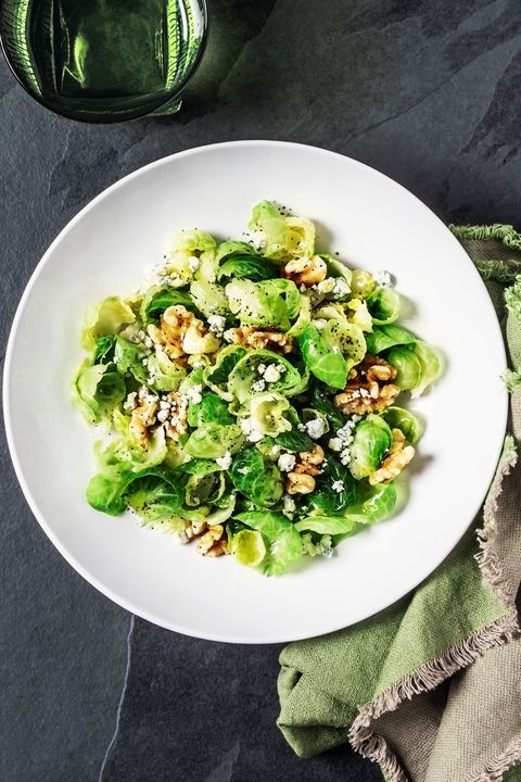 fresh salad with brussels sprouts and walnuts on black background