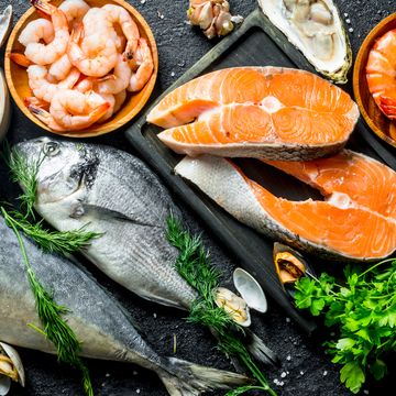 fresh salmon steak with a variety of seafood and herbs.