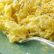 fresh scrambled eggs on green plate