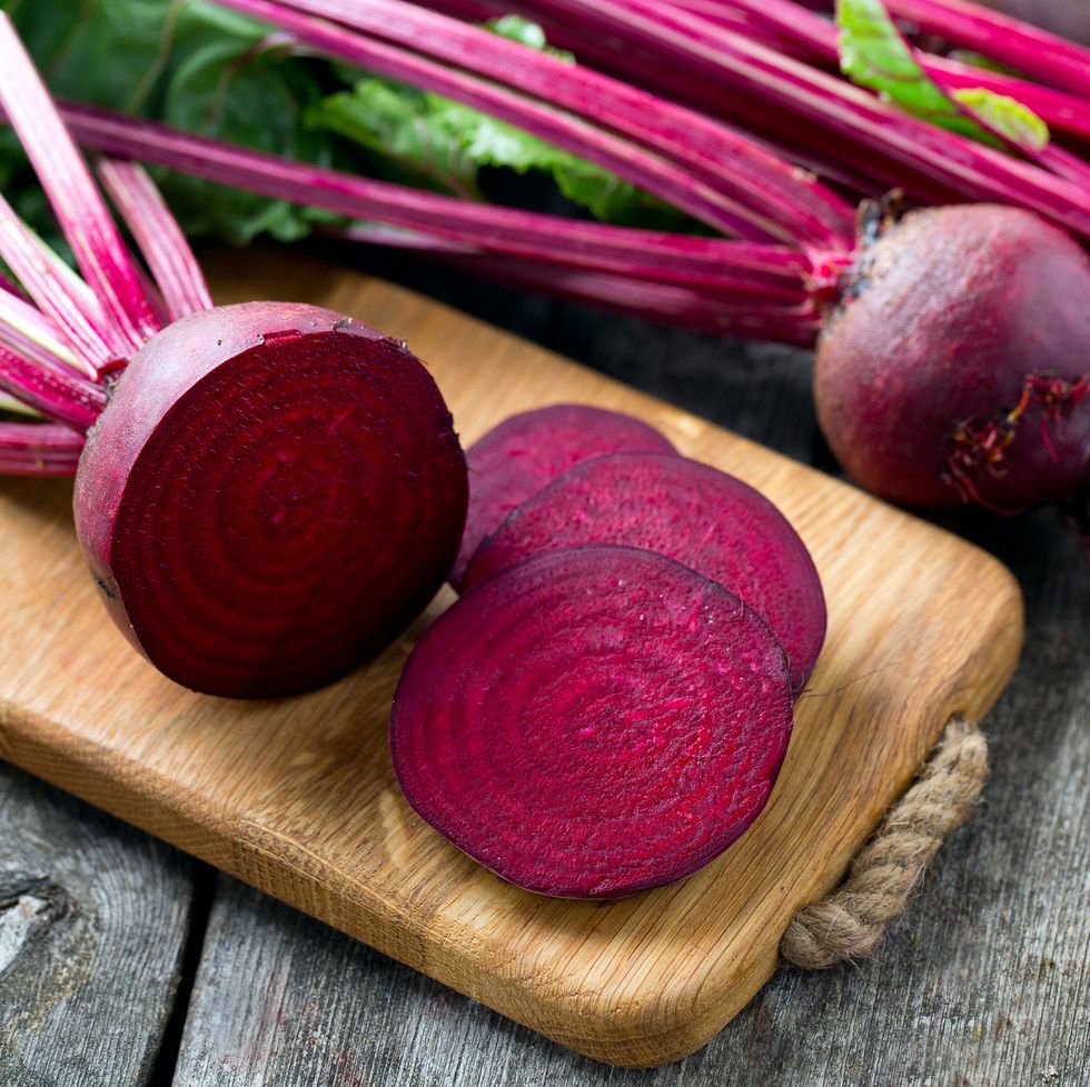 fresh sliced beetroot on wooden surface
