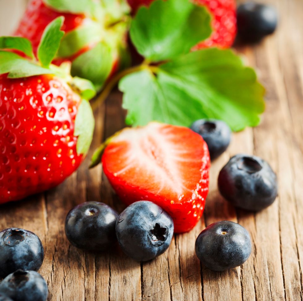 fresh strawberries and blueberries on wooden background