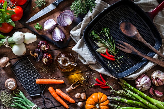 Fresh vegetables ready for cooking shot on rustic wooden table
