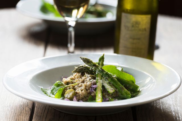 freshly prepared meal with asparagus and chives, close up