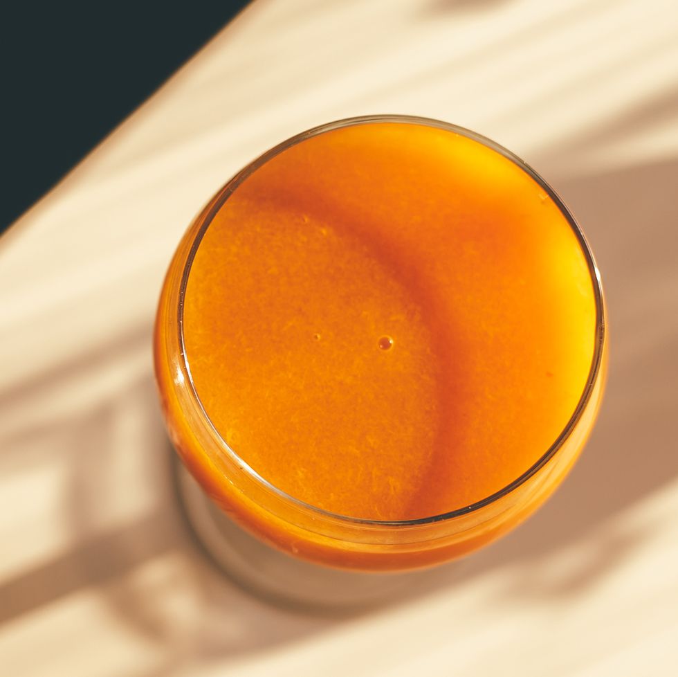 freshly squeezed apricot juice in a glass jar on table with shadow sunlights directly above with copy space banner for web site and design
