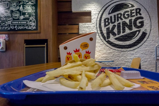 fried chips and chicken on the table in a burger king
