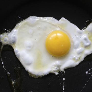 fried egg on black background